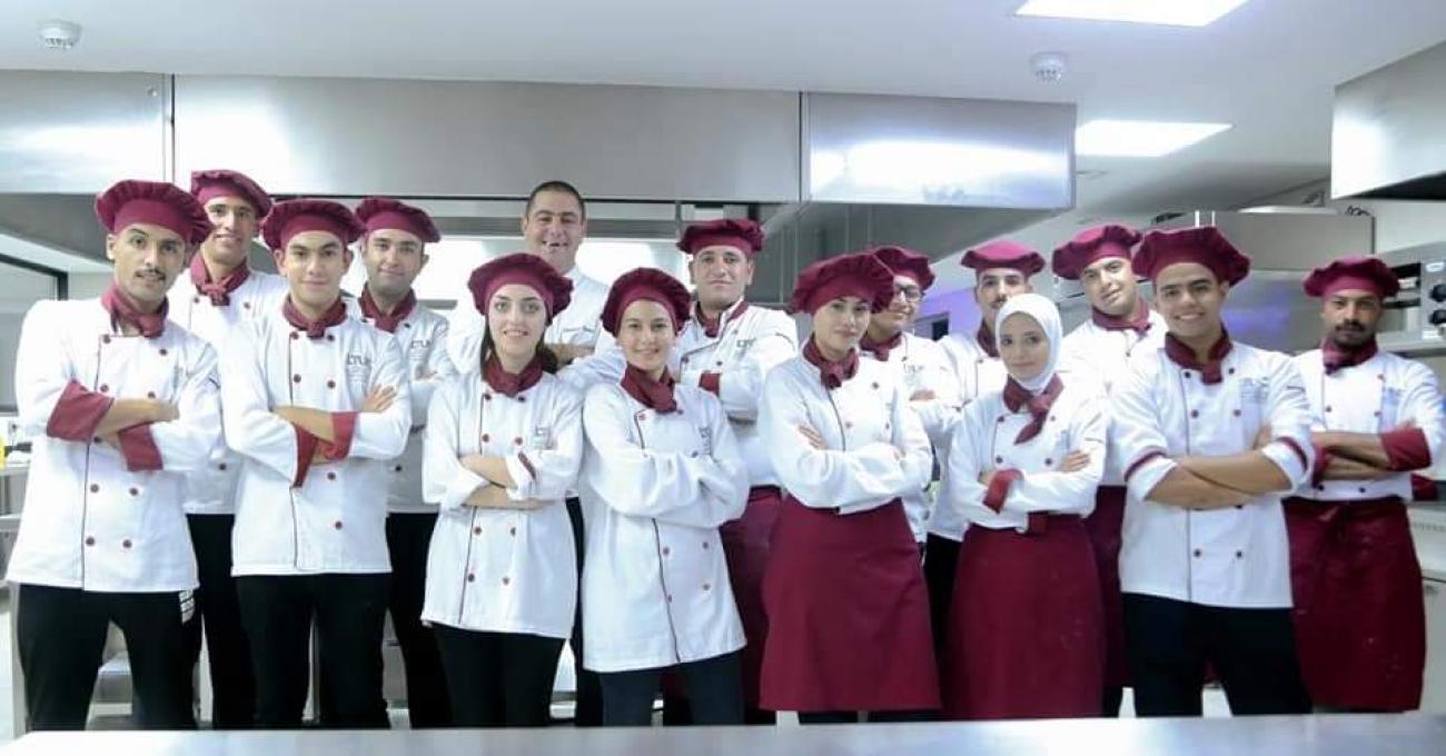 Aseel (third from right) takes a picture with her classmates at the end of her TVET training program, March 2020